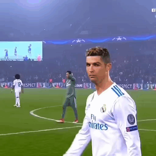 Soccer Player in Fly Emirates Jersey on Field