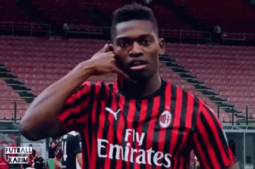 Soccer Player In Fly Emirates Jersey Talking On Phone GIF