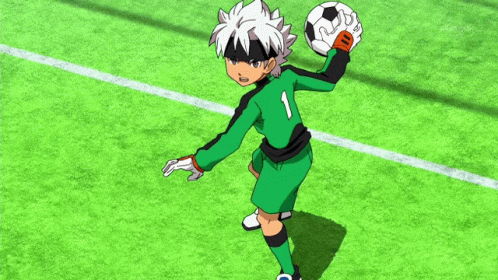 Soccer Player in Green and Black Uniform Holding Ball