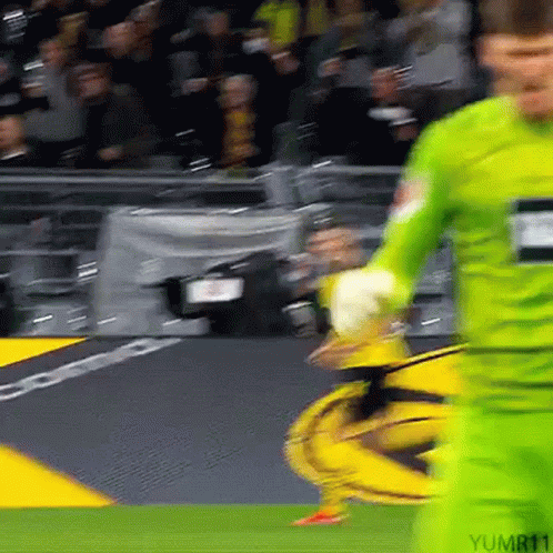 Soccer Player in Green Jersey Kicking Ball