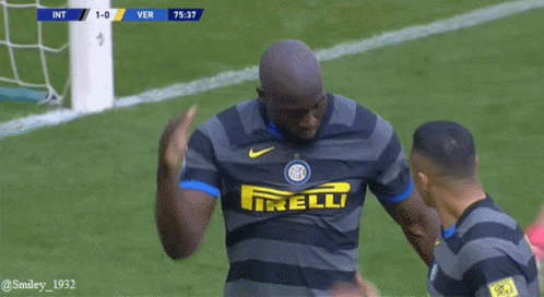 Soccer Player in Irelli Jersey Arm Around Another Player