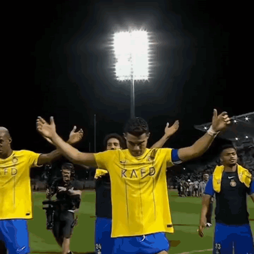 Soccer Player in Kafd Jersey Arms Outstretched