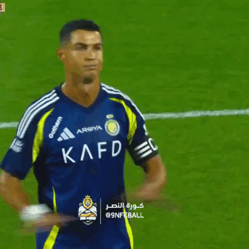 Soccer Player in Kafd Jersey on Field