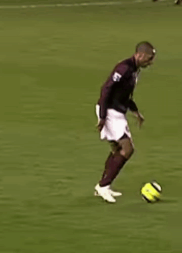 Soccer Player in Maroon Jersey and White Shorts Running