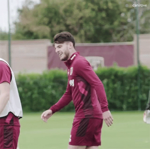 Soccer Player in Maroon Shirt and Shorts Smiling