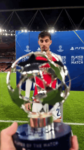 Soccer Player in Mira Jersey Holding Trophy