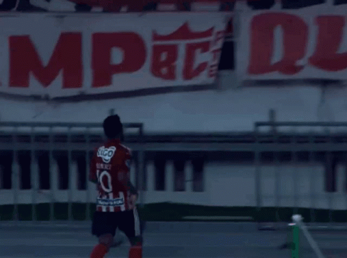Soccer Player in Number 10 Jersey in Front of Banner
