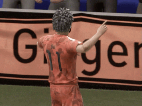 Soccer Player in Number 11 Jersey Points to Sign Saying Ginger