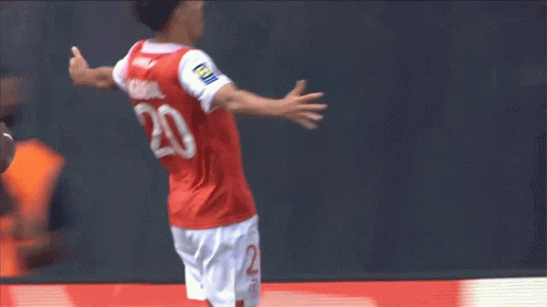 Soccer Player in Number 20 Jersey Jumping