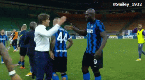 Soccer Player in Number 44 Jersey Hugging Another Player