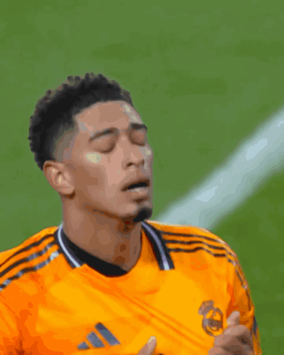 Soccer Player in Orange Adidas Jersey Looking Down