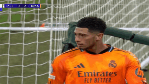 Soccer Player in Orange Jersey Emirates Fly Better