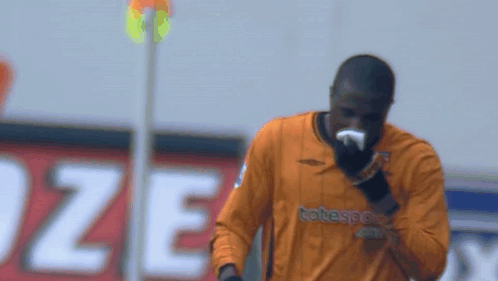 Soccer Player in Orange Totesport Jersey