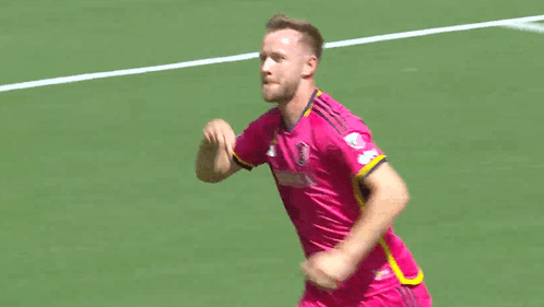 Soccer Player in Pink Purina Jersey Running