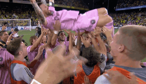 Soccer Player In Pink Shirt Thrown In Air GIF