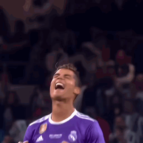 Soccer Player in Purple Fly Emirates Jersey Laughing in Front of Crowd
