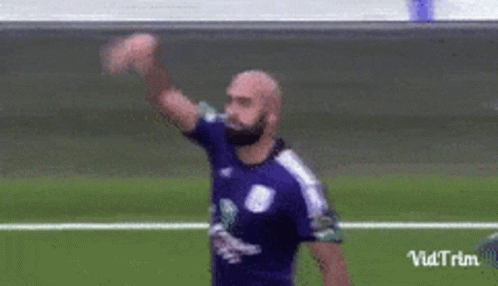 Soccer Player in Purple Shirt Waving