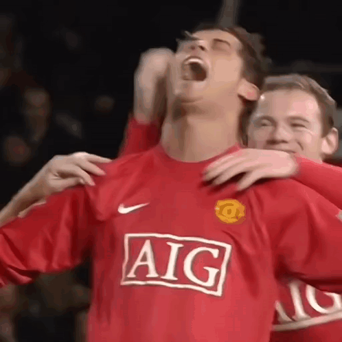 Soccer Player in Red AIG Jersey Hugged