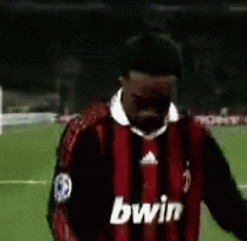 Soccer Player in Red and Black Bwin Jersey