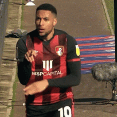 Soccer Player in Red and Black Jersey