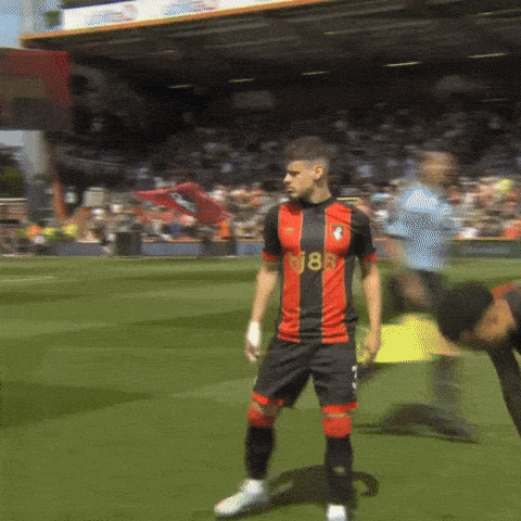 Soccer Player in Red and Black Jersey Number 18