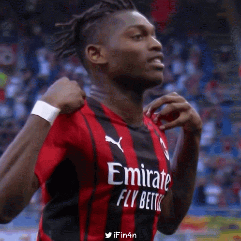 Soccer Player in Red and Black Jersey Saying Emirate Fly Better
