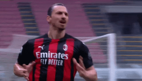 Soccer Player in Red and Black Jersey Saying Emirates Fly Better
