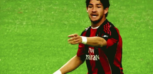 Soccer Player in Red and Black Jersey with Fly Emirates