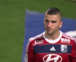 Soccer Player in Red and Blue Jersey With Letter H