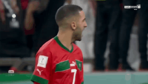 Soccer Player in Red and Green Jersey Number 7