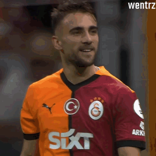 Soccer Player in Red and Orange Jersey With Six on Sleeve
