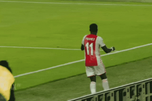 Soccer Player in Red and White Ajax Jersey