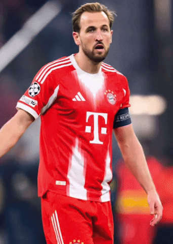 Soccer Player in Red and White Uniform With Letter T