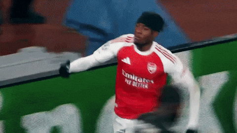 Soccer Player in Red Emirates Fly Better Jersey