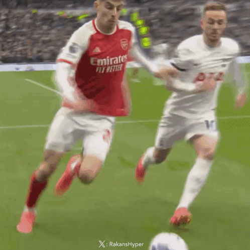 Soccer Player in Red Emirates Fly Better Jersey Running Towards Ball