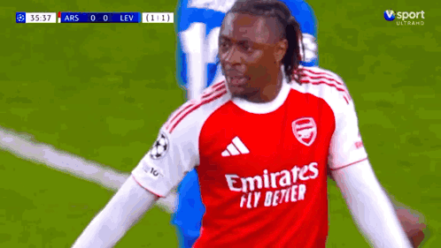 Soccer Player in Red Emirates Fly Better Shirt