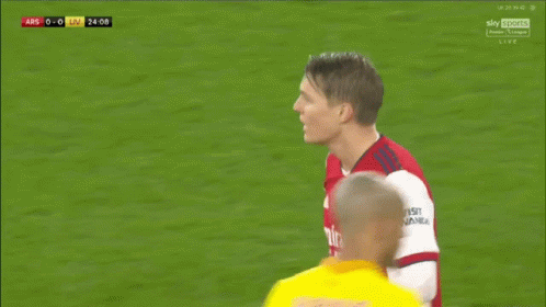 Soccer Player In Red Emirates Fly Better Shirt Talking To Player GIF