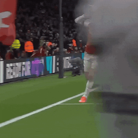 Soccer Player in Red Emirates Jersey