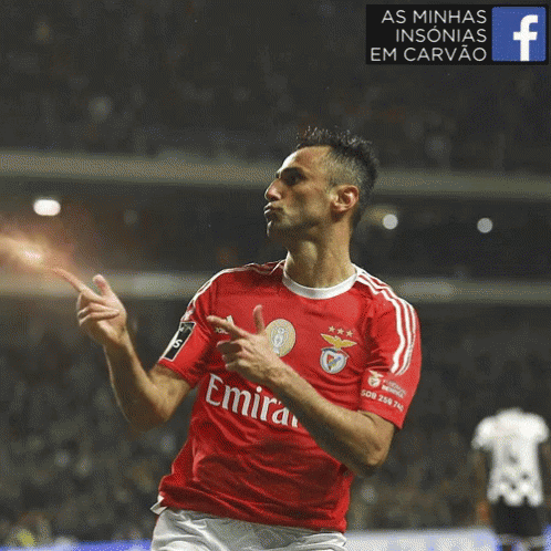 Soccer Player in Red Emirates Jersey Celebrating Goal