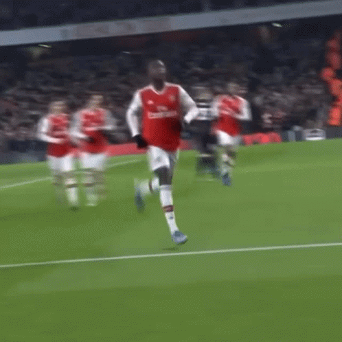 Soccer Player in Red Emirates Jersey Running