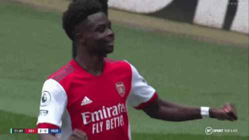Soccer Player in Red Fly Emirates Jersey