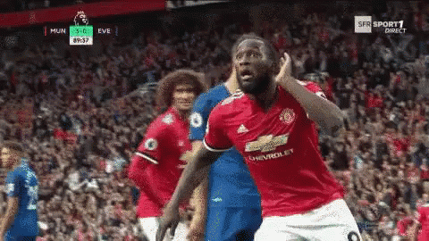 Soccer Player in Red Jersey Celebrating Goal