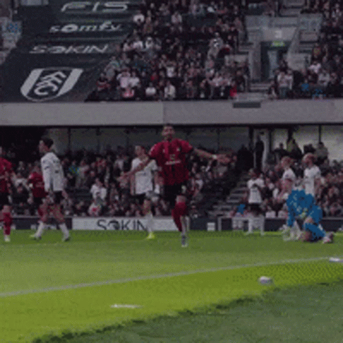 Soccer Player in Red Jersey Kicking Ball