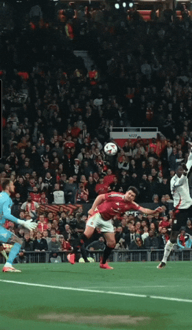 Soccer Player in Red Jersey Kicks Ball
