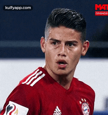 Soccer Player In Red Jersey Looking At Camera GIF