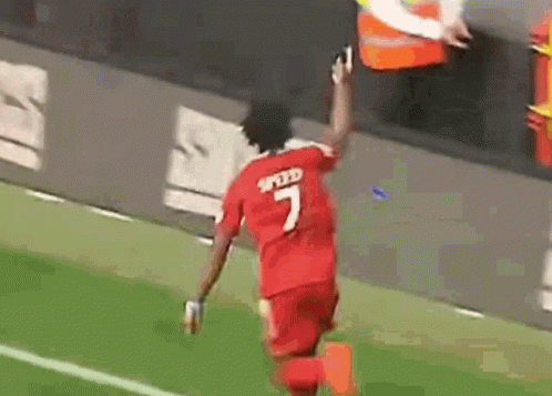 Soccer Player in Red Jersey Number 7 Running