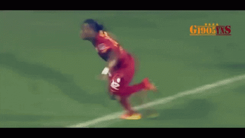 Soccer Player in Red Jersey Number 7 Running