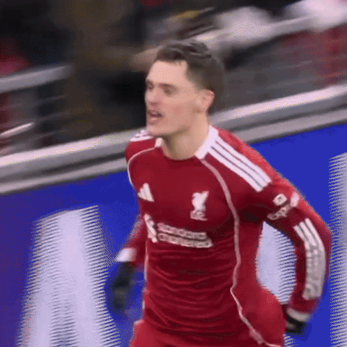 Soccer Player in Red Jersey Saying Standard Chartered