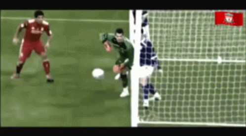 Soccer Player in Red Liverpool Jersey Kicking Ball