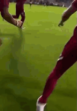 Soccer Player in Red Pants Kicking Soccer Ball